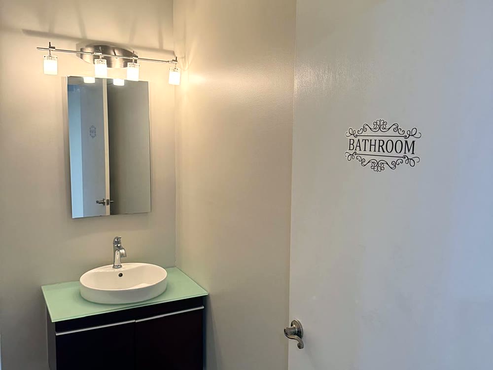 Repainted restroom with vanity and mirror